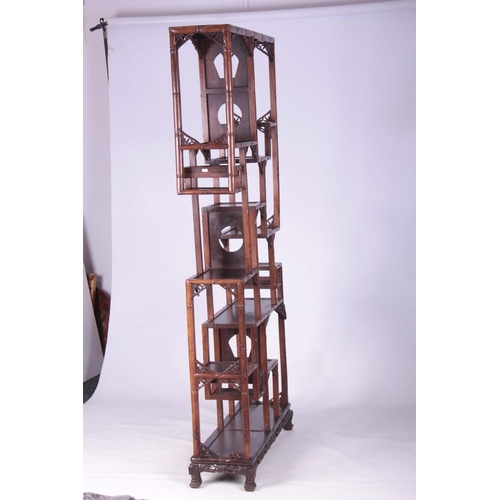 203 - A 19TH CENTURY CHINESE CHICKEN WING WOOD STANDING WHATNOT with a faux bamboo frame and leaf carved c... 