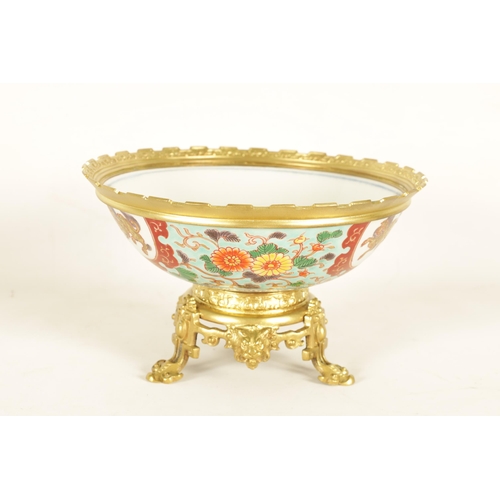 210 - AN ORMOLU MOUNTED CHINESE BOWL pale blue ground with floral decoration enclosing foo dog panels, the... 