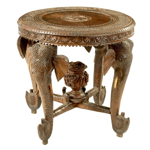 216 - A LATE 19TH CENTURY CARVED INDIAN 'ELEPHANT' TABLE having a carved oval top supported on four legs f... 