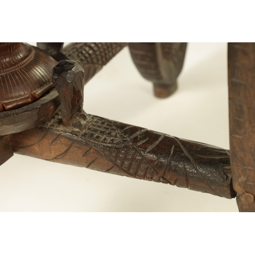 216 - A LATE 19TH CENTURY CARVED INDIAN 'ELEPHANT' TABLE having a carved oval top supported on four legs f... 