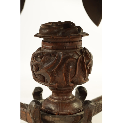 216 - A LATE 19TH CENTURY CARVED INDIAN 'ELEPHANT' TABLE having a carved oval top supported on four legs f... 