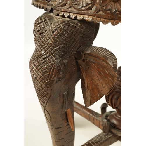 216 - A LATE 19TH CENTURY CARVED INDIAN 'ELEPHANT' TABLE having a carved oval top supported on four legs f... 