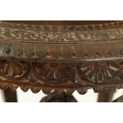 216 - A LATE 19TH CENTURY CARVED INDIAN 'ELEPHANT' TABLE having a carved oval top supported on four legs f... 