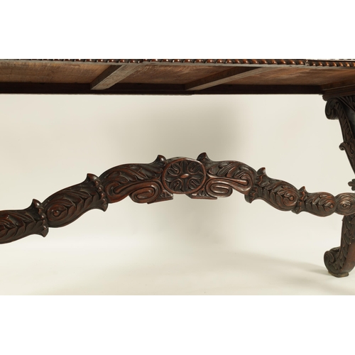 217 - A REGENCY ANGLO INDIAN CARVED HARDWOOD LIBRARY TABLE of good colour and patina, the polished top wit... 