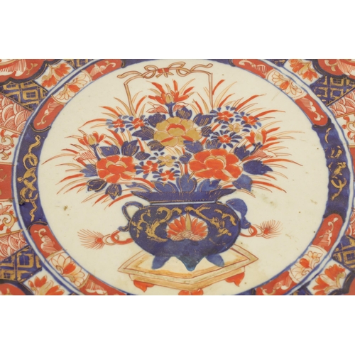 219 - A 19TH CENTURY IMARI CHARGER with fluted border decorated brightly coloured floral designs high-ligh... 