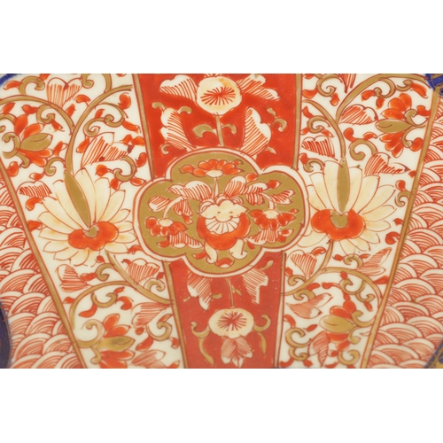 219 - A 19TH CENTURY IMARI CHARGER with fluted border decorated brightly coloured floral designs high-ligh... 