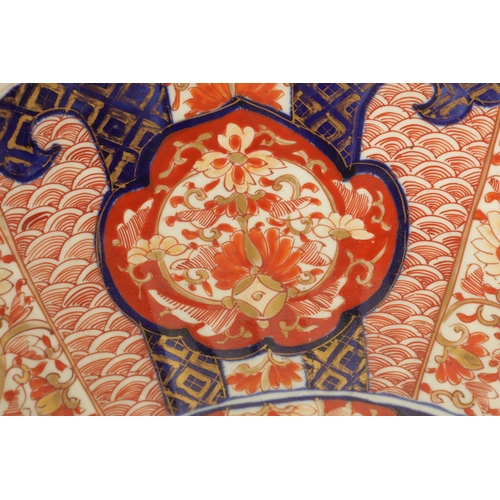 219 - A 19TH CENTURY IMARI CHARGER with fluted border decorated brightly coloured floral designs high-ligh... 