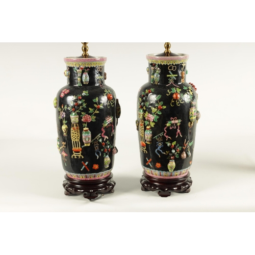 223 - A PAIR OF CHINESE REPUBLIC FAMILLE NOIRE PORCELAIN VASES CONVERTED INTO TABLE LAMPS each decorated w... 