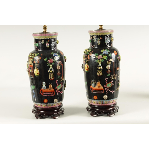 223 - A PAIR OF CHINESE REPUBLIC FAMILLE NOIRE PORCELAIN VASES CONVERTED INTO TABLE LAMPS each decorated w... 