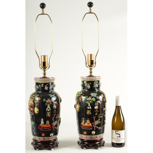 223 - A PAIR OF CHINESE REPUBLIC FAMILLE NOIRE PORCELAIN VASES CONVERTED INTO TABLE LAMPS each decorated w... 