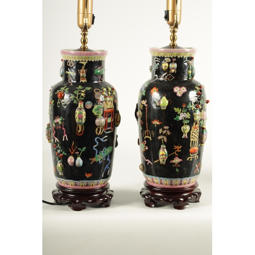 223 - A PAIR OF CHINESE REPUBLIC FAMILLE NOIRE PORCELAIN VASES CONVERTED INTO TABLE LAMPS each decorated w... 