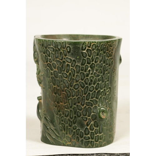 224 - A CHINESE SPANISH GREEN JADE BRUSH POT of naturalistic form with chinese script (13cm high 12cm wide... 