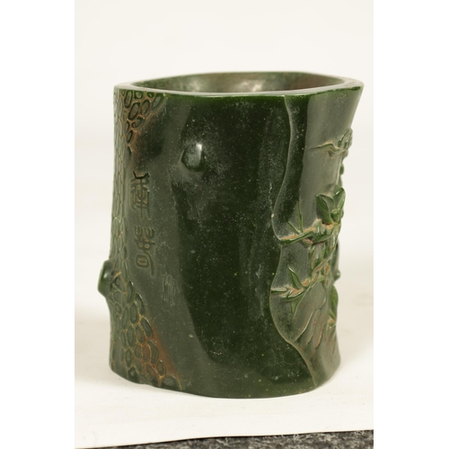 224 - A CHINESE SPANISH GREEN JADE BRUSH POT of naturalistic form with chinese script (13cm high 12cm wide... 