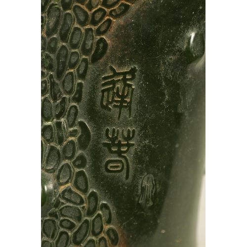 224 - A CHINESE SPANISH GREEN JADE BRUSH POT of naturalistic form with chinese script (13cm high 12cm wide... 