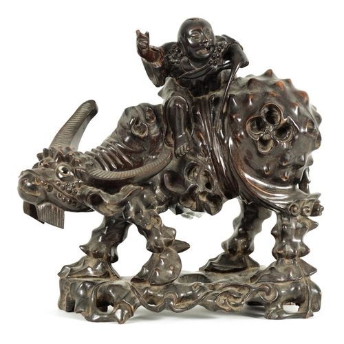 225 - A 19TH CENTURY CHINESE CARVED HARDWOOD SCULPTURE OF A WATER BUFFALO AND RIDER with glass eyes (29cm ... 