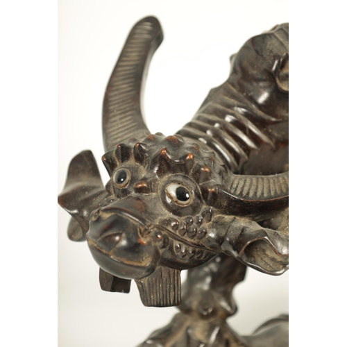 225 - A 19TH CENTURY CHINESE CARVED HARDWOOD SCULPTURE OF A WATER BUFFALO AND RIDER with glass eyes (29cm ... 