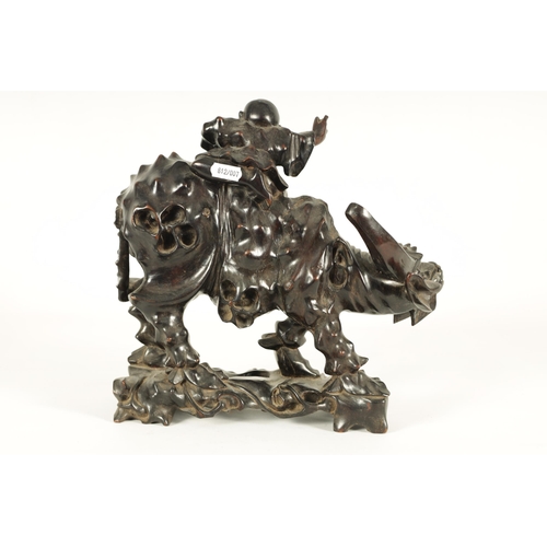 225 - A 19TH CENTURY CHINESE CARVED HARDWOOD SCULPTURE OF A WATER BUFFALO AND RIDER with glass eyes (29cm ... 