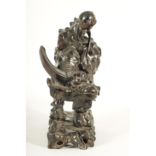 225 - A 19TH CENTURY CHINESE CARVED HARDWOOD SCULPTURE OF A WATER BUFFALO AND RIDER with glass eyes (29cm ... 