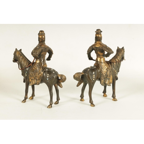 230 - A PAIR OF GILT BRONZE 18TH CENTURY STYLE CHINESE EQUESTRIAN FIGURES of mounted warriors with jewelle... 