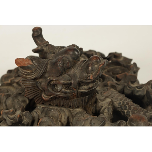 231 - A 19TH CENTURY CHINESE CARVED HARDWOOD VASE LID - POSSIBLY ZITAN with a finely carved entwined drago... 