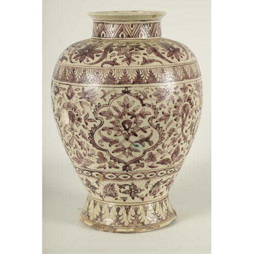 232 - AN EARLY PERSIAN EARTHENWARE LARGE TAPERING SHOULDERED FOOTED VASE with all round floral and leaf ba... 