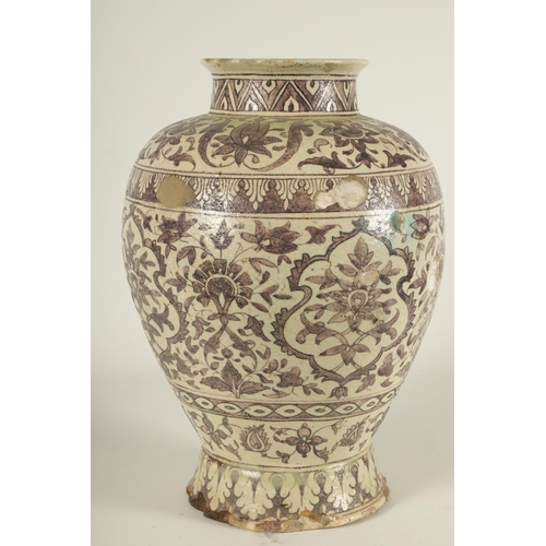 232 - AN EARLY PERSIAN EARTHENWARE LARGE TAPERING SHOULDERED FOOTED VASE with all round floral and leaf ba... 