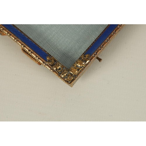 279 - A 19TH CENTURY FRENCH GILT BRASS AND BLUE GUILLOCHE ENAMEL PICTURE FRAME OF SMALL SIZE with flower h... 