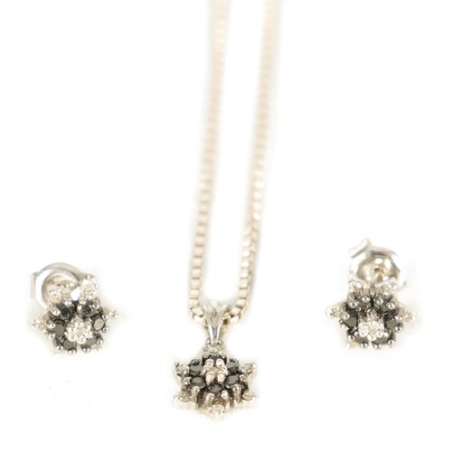 283 - A SET OF VINTAGE 9CT WHITE GOLD BLACK DIAMOND NECKLACE AND EARRINGS with six-point stars on a square... 