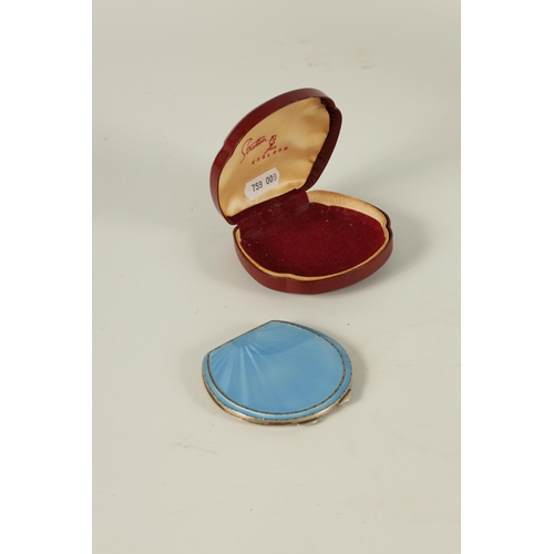 290 - A GEORGE VI SILVER AND GUILLOCHE ENAMEL HORSESHOE SHAPED COMPACT with sunburst design opening to rev... 