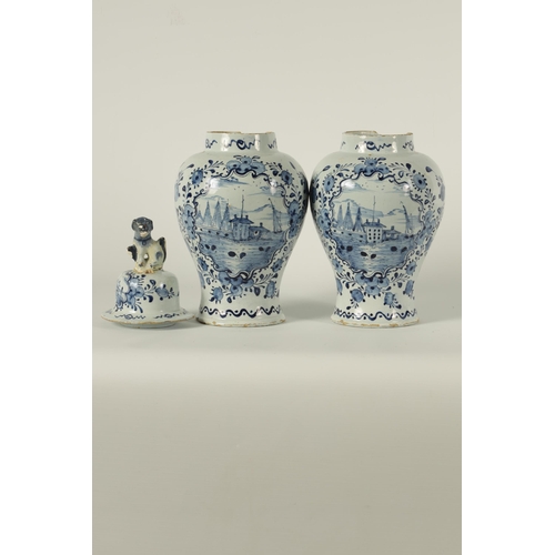 36 - A PAIR OF 18TH CENTURY BLUE AND WHITE DELFT VASES AND COVER the inverted baluster bodies decorated w... 