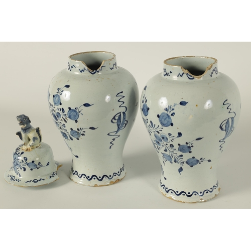 36 - A PAIR OF 18TH CENTURY BLUE AND WHITE DELFT VASES AND COVER the inverted baluster bodies decorated w... 