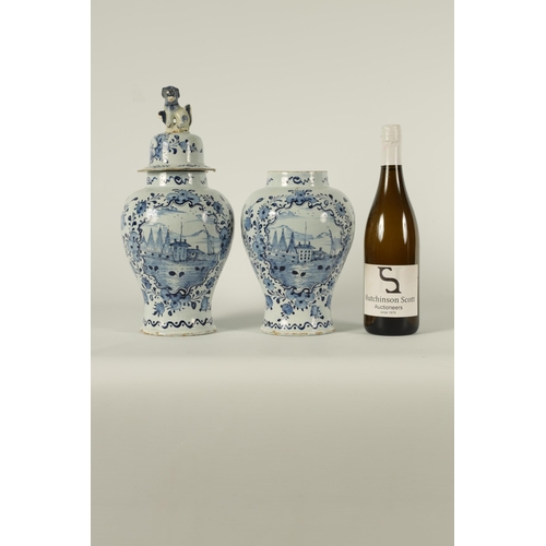 36 - A PAIR OF 18TH CENTURY BLUE AND WHITE DELFT VASES AND COVER the inverted baluster bodies decorated w... 