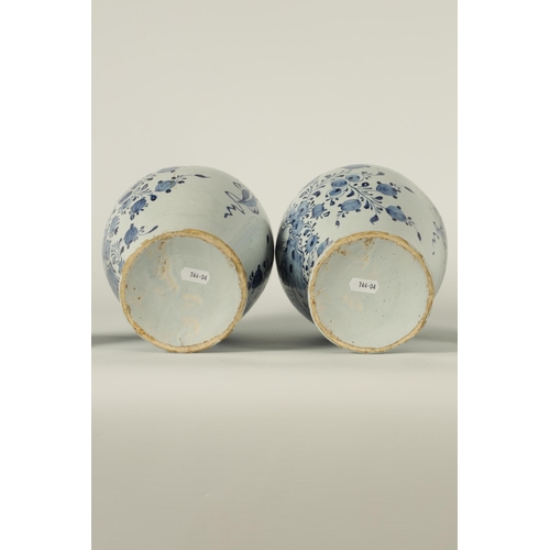 36 - A PAIR OF 18TH CENTURY BLUE AND WHITE DELFT VASES AND COVER the inverted baluster bodies decorated w... 