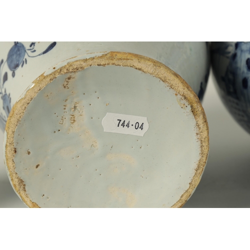 36 - A PAIR OF 18TH CENTURY BLUE AND WHITE DELFT VASES AND COVER the inverted baluster bodies decorated w... 