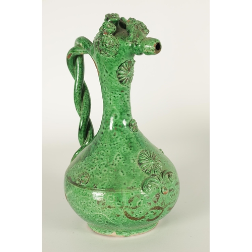 37 - AN OTTOMAN REVIVAL TURKISH GREEN GLAZED TERRACOTTA CANAKKALE EWER the bulbous body and slender taper... 