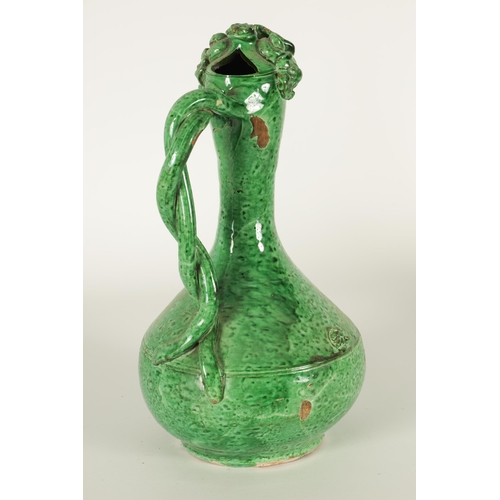 37 - AN OTTOMAN REVIVAL TURKISH GREEN GLAZED TERRACOTTA CANAKKALE EWER the bulbous body and slender taper... 