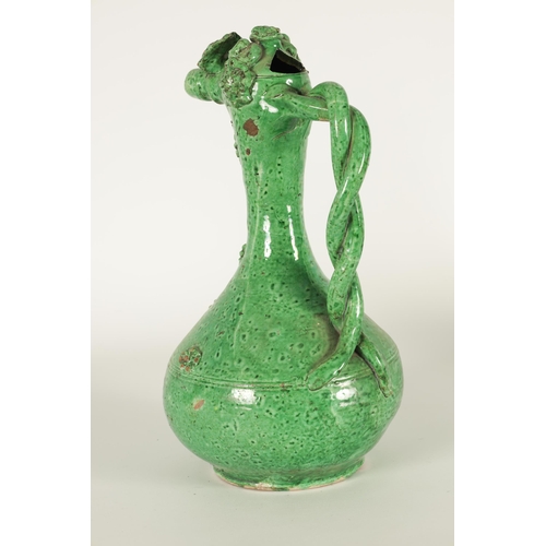 37 - AN OTTOMAN REVIVAL TURKISH GREEN GLAZED TERRACOTTA CANAKKALE EWER the bulbous body and slender taper... 