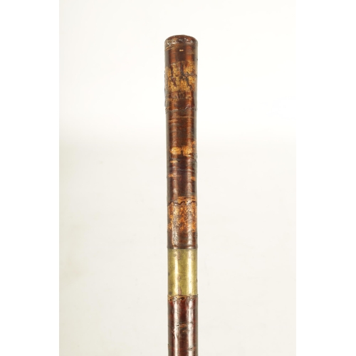 430 - A RARE MEIJI PERIOD JAPANESE SAMURAI SWORD STICK with lacquered stick, the handle enclosing a glazed... 