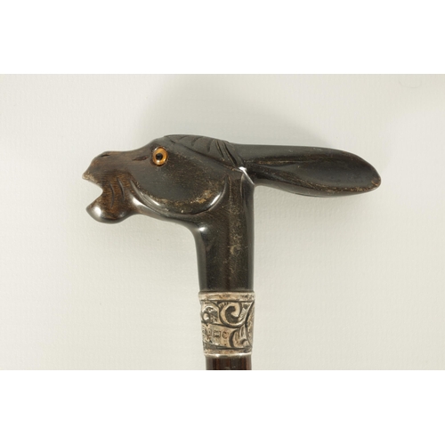 431 - A SELECTION OF THREE RHINOCEROS HORN HANDLED WALKING STICKS depicting a donkey, dog and parrot, moun... 