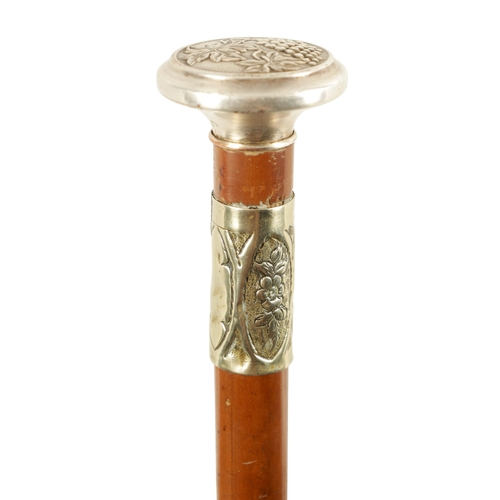 435 - AN ART NOUVEAU MALACCA AND SILVER METAL SWORD STICK the handle embossed with grapes on a vine and ma... 