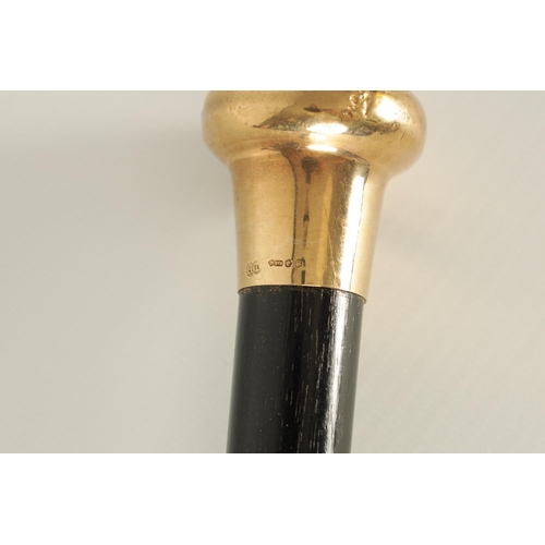 436 - A LATE 19TH CENTURY 9CT GOLD HANDLED WALKING STICK with ebonised tapering shaft - hallmarked .375 (9... 