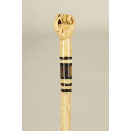 439 - A 19TH CENTURY WHALEBONE AND BALEEN BANDED WALKING STICK with sailors fist handle and tapering shaft... 