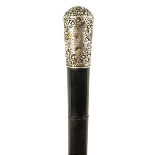 443 - A LATE 19TH CENTURY SILVER MOUNTED EBONISED SWORD STICK having a foliate and scrollwork embossed sil... 