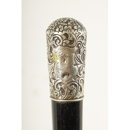 443 - A LATE 19TH CENTURY SILVER MOUNTED EBONISED SWORD STICK having a foliate and scrollwork embossed sil... 