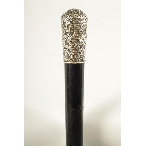 443 - A LATE 19TH CENTURY SILVER MOUNTED EBONISED SWORD STICK having a foliate and scrollwork embossed sil... 