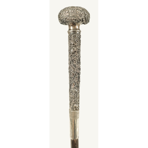 446 - A LATE 19TH CENTURY CHINESE SILVER MOUNTED RHINOCEROS HORN WALKING CANE profusely embossed with bird... 