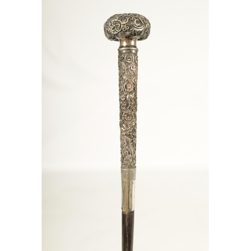 446 - A LATE 19TH CENTURY CHINESE SILVER MOUNTED RHINOCEROS HORN WALKING CANE profusely embossed with bird... 