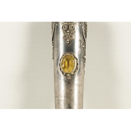 449 - AN EARLY 20TH CENTURY RHINOCEROS HORN SWAGGER STICK having a jewelled silvered metal handle with sil... 