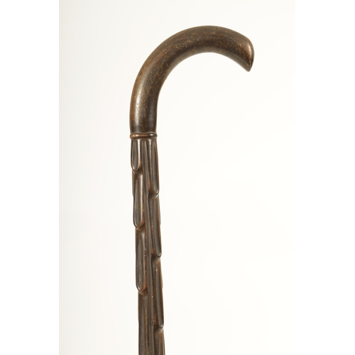 456 - A GOOD 19TH CENTURY RHINOCEROS HORN WALKING STICK with carved branchwork shaft and curved handle. (9... 