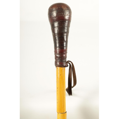 459 - AN EARLY 20TH CENTURY BAMBOO AND LEATHER DAGGER STICK the leather bound handle on a bamboo stick con... 